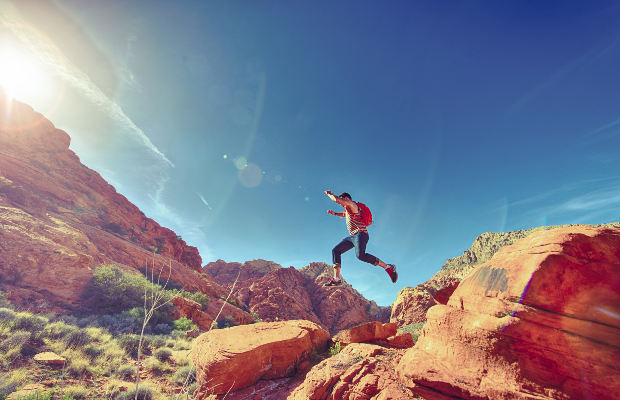 Athletic_Man_Jumping_Between_Rocks_In_Outdoor_National_Park