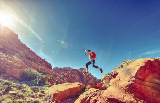 Athletic_Man_Jumping_Between_Rocks_In_Outdoor_National_Park